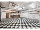 Large garage with ample storage and checkered tile floors at 8881 Lilly Dr, Thornton, CO 80229