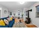 Open-concept living room with a cozy fireplace, hardwood floors, and stylish contemporary furnishings at 8881 Lilly Dr, Thornton, CO 80229