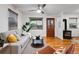 Bright living room featuring stylish furniture, a wood burning stove, and hardwood floors at 8881 Lilly Dr, Thornton, CO 80229