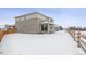 Two-story home with backyard and wooden fence in winter at 4527 Boone Cir, Brighton, CO 80601