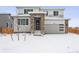 Two-story house with stone accents and a snow-covered front yard at 4527 Boone Cir, Brighton, CO 80601