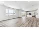 Kitchen with island, white cabinets and access to backyard at 4527 Boone Cir, Brighton, CO 80601