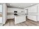 White kitchen with island and stainless steel appliances at 4527 Boone Cir, Brighton, CO 80601