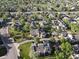 Wide aerial view of neighborhood featuring mature trees, green spaces, and manicured landscaping at 8394 S Everett Way # E, Littleton, CO 80128