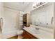 Well-lit bathroom with a shower-tub combination and rustic-style storage cabinet at 8394 S Everett Way # E, Littleton, CO 80128