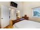 Comfortable bedroom features wood floors and a mounted TV, offering a relaxing retreat at 8394 S Everett Way # E, Littleton, CO 80128