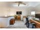 Loft-style bedroom with natural light, ceiling fan, and a dedicated workspace at 8394 S Everett Way # E, Littleton, CO 80128