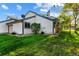 Exterior view of home with green lawn, white siding, dark trim, and chimney at 8394 S Everett Way # E, Littleton, CO 80128
