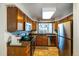 Efficient kitchen with stainless steel appliances, wooden cabinets, and a view from the window at 8394 S Everett Way # E, Littleton, CO 80128