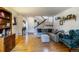 Bright living room with hardwood floors, a sectional sofa, and a staircase at 8394 S Everett Way # E, Littleton, CO 80128