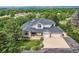 Aerial view of grand home with well-maintained landscaping and mature trees at 6335 Oberon Rd, Arvada, CO 80004