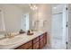 Bright bathroom features dual sinks, wood cabinetry, and a shower/tub combo at 6335 Oberon Rd, Arvada, CO 80004
