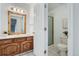 Bathroom with beautiful gold mirror over sink and walk-in shower at 6335 Oberon Rd, Arvada, CO 80004