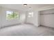Neutral bedroom with large windows, natural light, and carpeted floors at 6335 Oberon Rd, Arvada, CO 80004