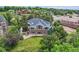 Stunning home featuring a spacious lawn, mature trees, and inviting outdoor living spaces and an upper level deck at 6335 Oberon Rd, Arvada, CO 80004