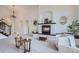 Bright living room features a fireplace, ample seating, and natural light streaming through open archways at 6335 Oberon Rd, Arvada, CO 80004