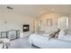 Bright primary bedroom with neutral carpet, fireplace, walk-in closet and ensuite bathroom at 6335 Oberon Rd, Arvada, CO 80004