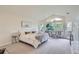 Spacious main bedroom features sitting area, neutral carpet, large windows and private deck at 6335 Oberon Rd, Arvada, CO 80004
