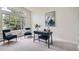Home office featuring a large window, comfortable seating, stylish desk, and decorative artwork at 6335 Oberon Rd, Arvada, CO 80004