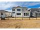Back exterior view of a two-story home in a new development with fencing and landscaping at 25234 E Warren Pl, Aurora, CO 80018