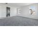 Well-lit bedroom with neutral colored carpet, neutral paint, and natural light at 25234 E Warren Pl, Aurora, CO 80018