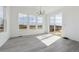 Bright dining area with hardwood floors, large windows offering scenic views, and a modern chandelier at 25234 E Warren Pl, Aurora, CO 80018