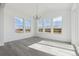 Bright dining area with hardwood floors, large windows offering scenic views, and a modern chandelier at 25234 E Warren Pl, Aurora, CO 80018