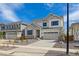 Charming two-story home with neutral siding, stone accents, well-manicured landscaping, and an attached two-car garage at 25234 E Warren Pl, Aurora, CO 80018