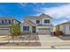 Charming two-story home with neutral siding, stone accents, well-manicured landscaping, and an attached two-car garage at 25234 E Warren Pl, Aurora, CO 80018