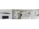 Open-concept kitchen with white cabinets, an island, stainless steel appliances, and subway tile backsplash at 25234 E Warren Pl, Aurora, CO 80018