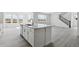 Open-concept kitchen with center island, stainless steel appliances, and a view into the dining and living areas at 25234 E Warren Pl, Aurora, CO 80018