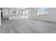 Bright living room with luxury vinyl plank flooring, modern design, and large windows at 25234 E Warren Pl, Aurora, CO 80018