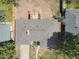 Bird's-eye view of the house highlighting the roof, landscaping, and the building under construction at the back at 404 S Oneida Way, Denver, CO 80224
