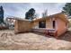 Exterior view of backyard and new construction featuring brick and wood paneling at 404 S Oneida Way, Denver, CO 80224
