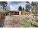 Exterior view of the home's backyard with dirt lot and framing for an extension at 404 S Oneida Way, Denver, CO 80224