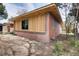 Exterior view of home featuring new wood siding and brick base at 404 S Oneida Way, Denver, CO 80224