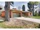 Charming home with a green garage door, brick accents, and a mature tree in the front yard at 404 S Oneida Way, Denver, CO 80224