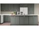 This kitchen features gray cabinets, white countertops, and stainless steel appliances at 404 S Oneida Way, Denver, CO 80224