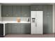 This kitchen features gray cabinets, white countertops, and stainless steel appliances at 404 S Oneida Way, Denver, CO 80224