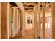 Hallway under construction showcases the framing with electrical wiring and plumbing, offering customizable potential at 404 S Oneida Way, Denver, CO 80224