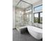 Elegant bathroom featuring a soaking tub, glass-enclosed shower, and modern fixtures at 5224 Lions Paw St, Castle Rock, CO 80104