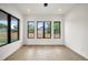 Bright dining room with hardwood floors, sleek lighting, and large windows overlooking the yard at 5224 Lions Paw St, Castle Rock, CO 80104