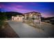 Modern home showcasing a three-car garage, stone accents, and clean architectural lines at 5224 Lions Paw St, Castle Rock, CO 80104