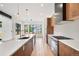 Modern kitchen features sleek cabinets, a large island with seating, and stainless-steel appliances at 5224 Lions Paw St, Castle Rock, CO 80104