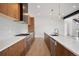 Bright kitchen features custom cabinets, stainless appliances, sleek countertops, and backsplash detail at 5224 Lions Paw St, Castle Rock, CO 80104