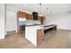 Modern kitchen featuring stainless steel appliances, custom cabinets, and a large island with countertop seating at 5224 Lions Paw St, Castle Rock, CO 80104