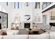 Bright living room features soaring ceilings, fireplace, stylish decor, and large windows allowing for ample natural light at 5224 Lions Paw St, Castle Rock, CO 80104
