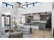 Open-concept living area flows into modern kitchen with stainless steel appliances, island, and ample counter space at 5224 Lions Paw St, Castle Rock, CO 80104