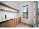 Modern pantry with custom cabinets, countertop and a beverage cooler near an exterior door at 5224 Lions Paw St, Castle Rock, CO 80104