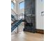 Modern staircase design featuring wood and steel accents alongside a striking fireplace feature at 5224 Lions Paw St, Castle Rock, CO 80104